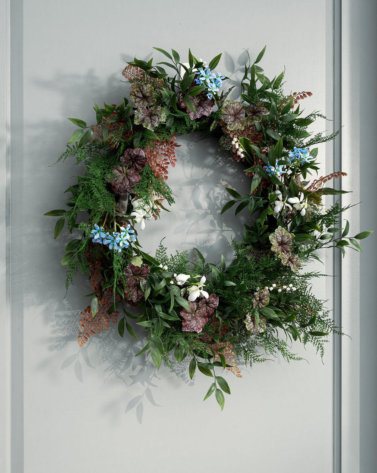 Couronne de fougères artificielles et de bégonias